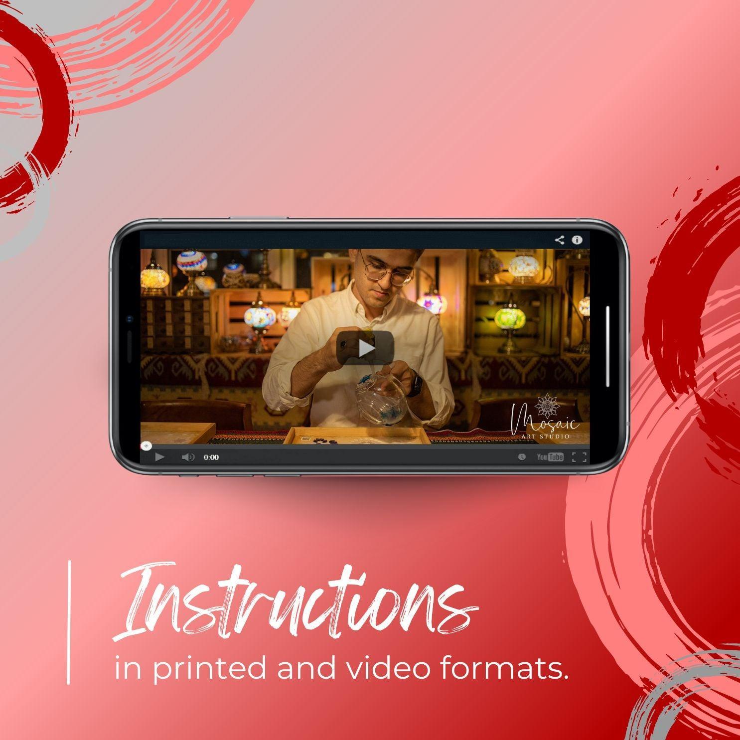 Smartphone showing DIY mosaic candle holder tutorial video, with warm decorative lamps in background