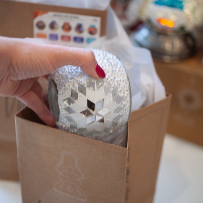 The mosaic globe coming out of the kit box