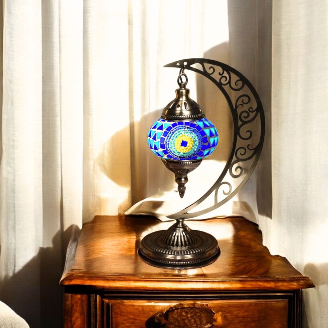 Handmade Turkish mosaic moon lamp glowing on a bedside table